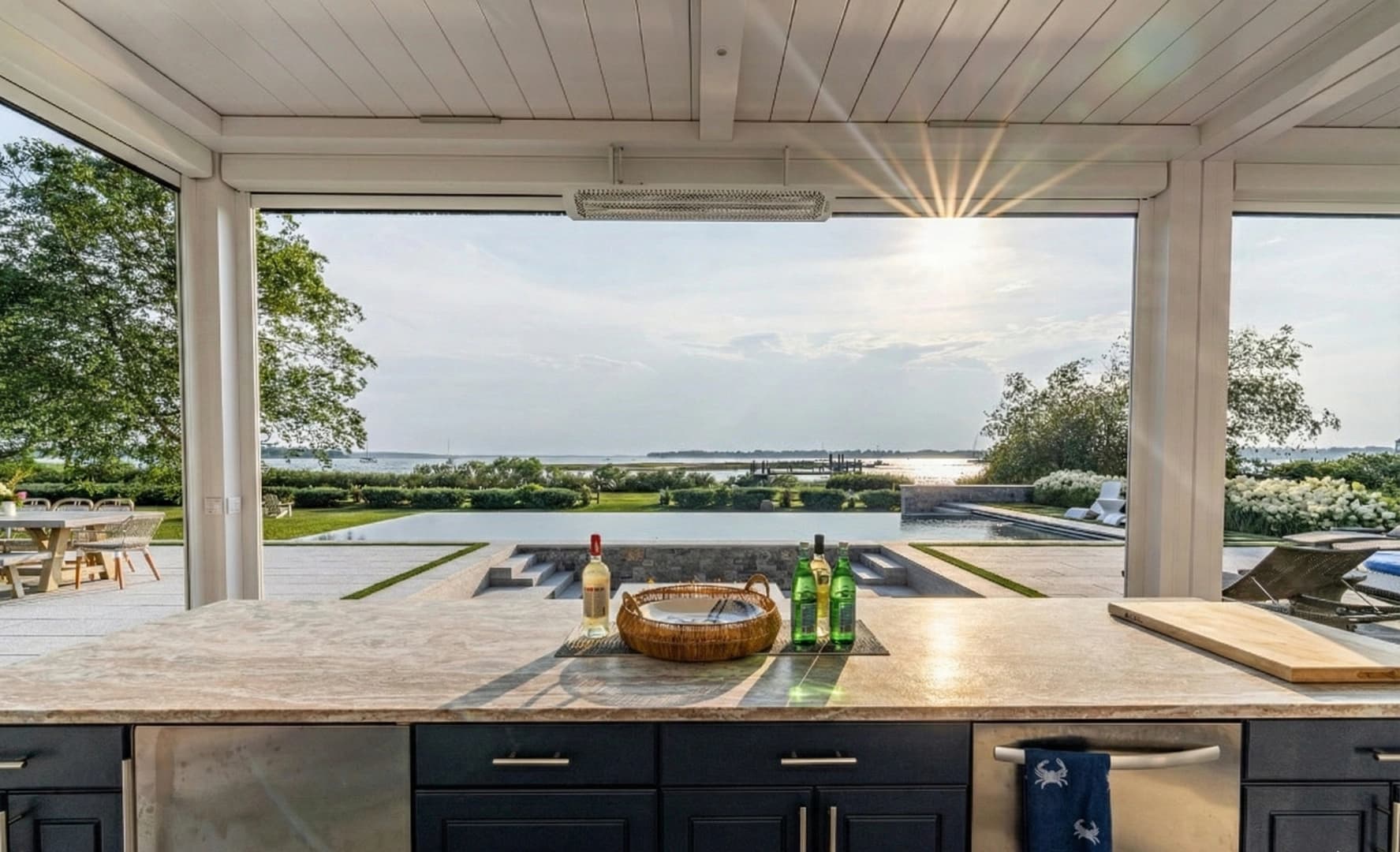 Professional outdoor kitchen with premium stone counters and built-in grill by Redwood