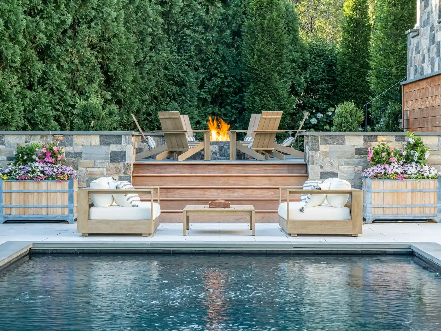 Intimate outdoor gathering space with fire feature at golden hour