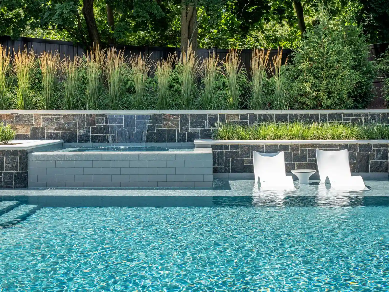 Stunning resort-caliber pool at dusk with integrated landscape lighting